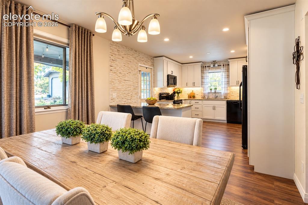 Image 9 of 30: Wood-finish flooring throughout, with a stacked stone accent wall