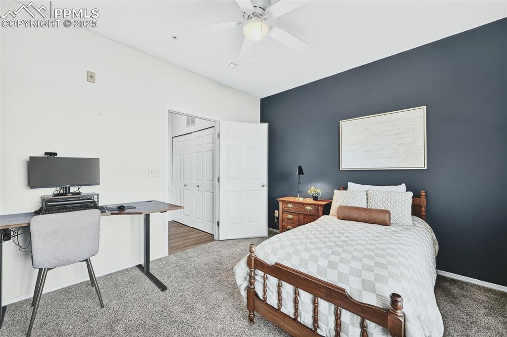 Image 18 of 25: Bedroom featuring carpet floors, a ceiling fan, a desk, and a closet