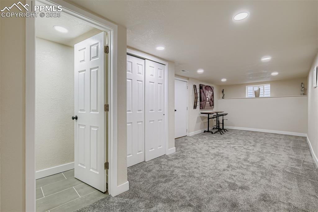 Image 24 of 31: Large bonus room/suite in basement (non-conforming); adjacent bath and clos