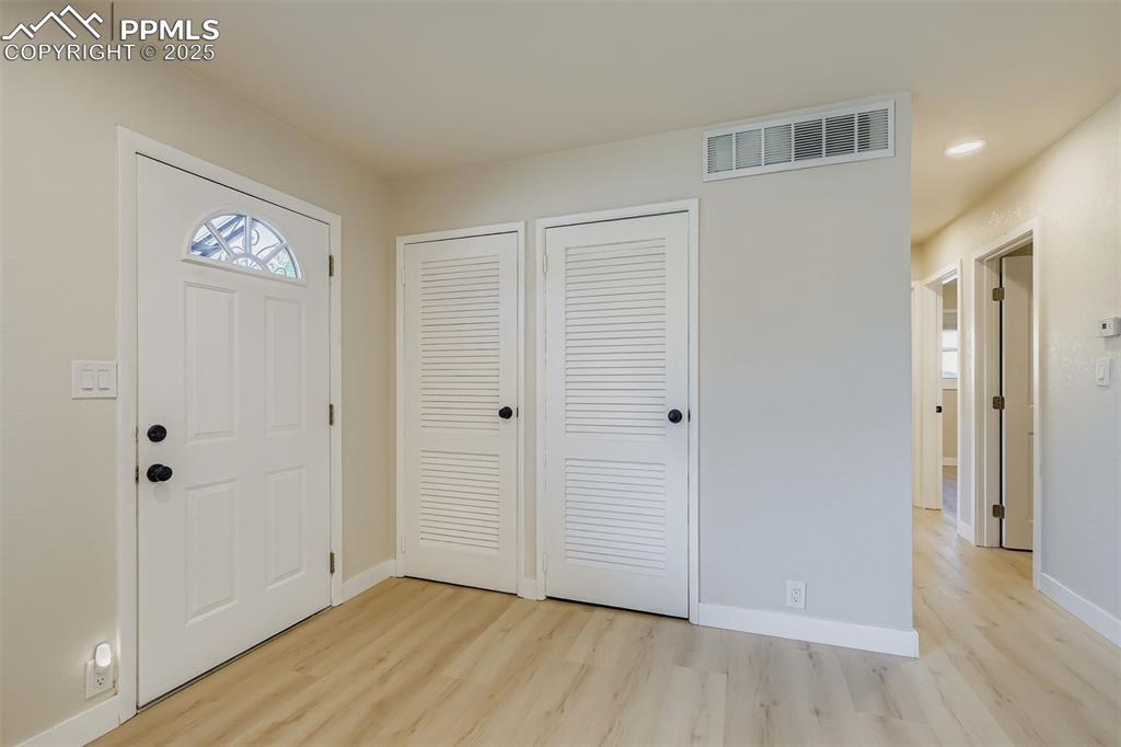 Image 6 of 31: Entry with coat closet and utility room