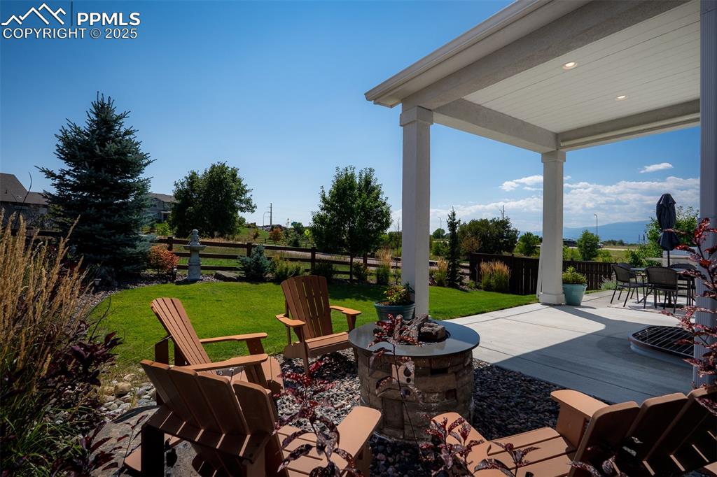 Image 6 of 37: View of patio with an outdoor fire pit