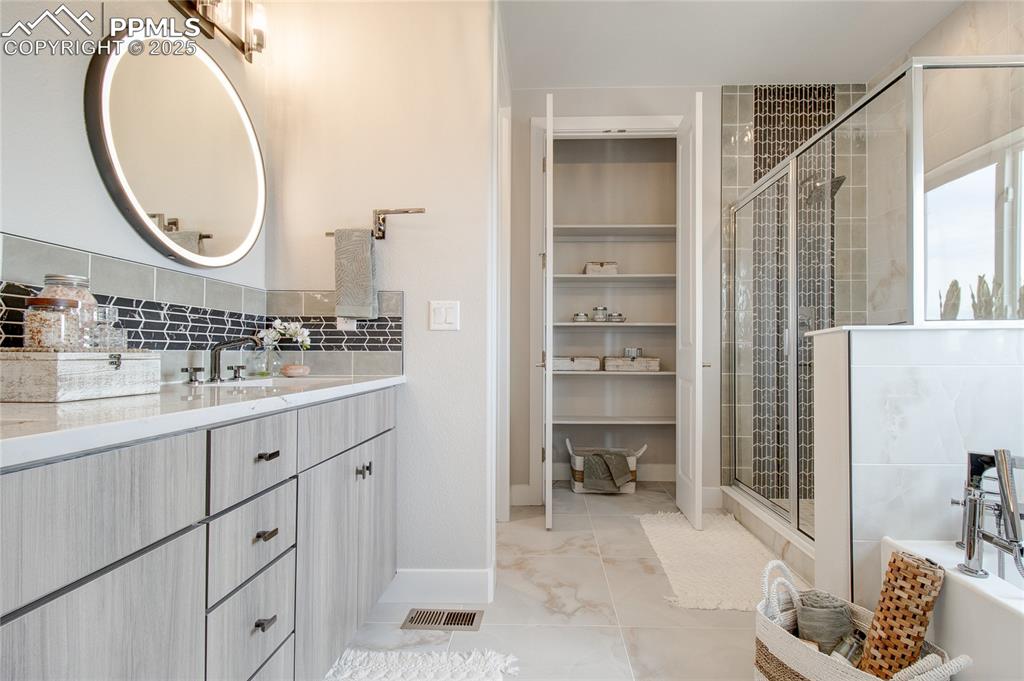 Image 12 of 29: Full bath with vanity and a shower stall