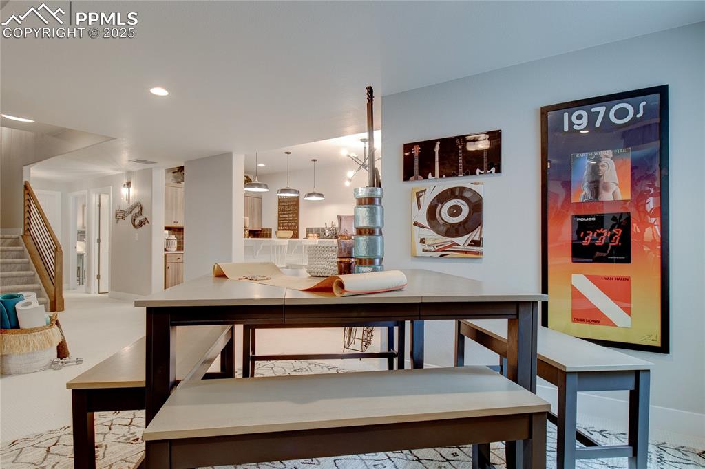 Image 24 of 29: Dining space featuring stairway and recessed lighting