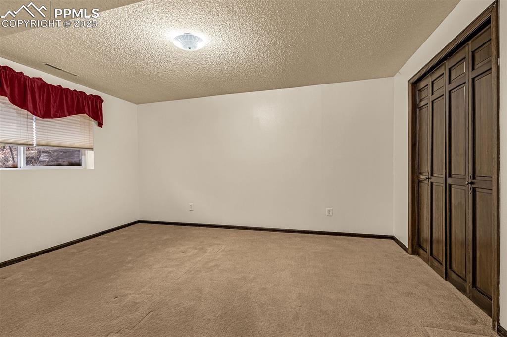 Image 25 of 50: Lower level bedroom with large closet