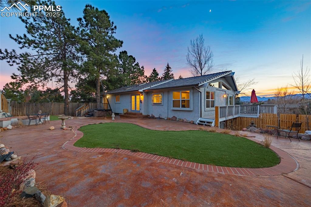 Image 38 of 50: Back of property at dusk featuring a patio area, a fenced backyard, a woode