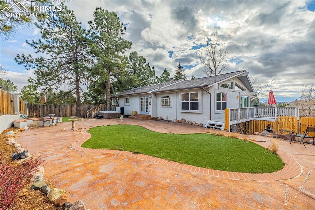 Image 39 of 50: Rear view of house featuring a patio, a fenced backyard, stucco siding, and