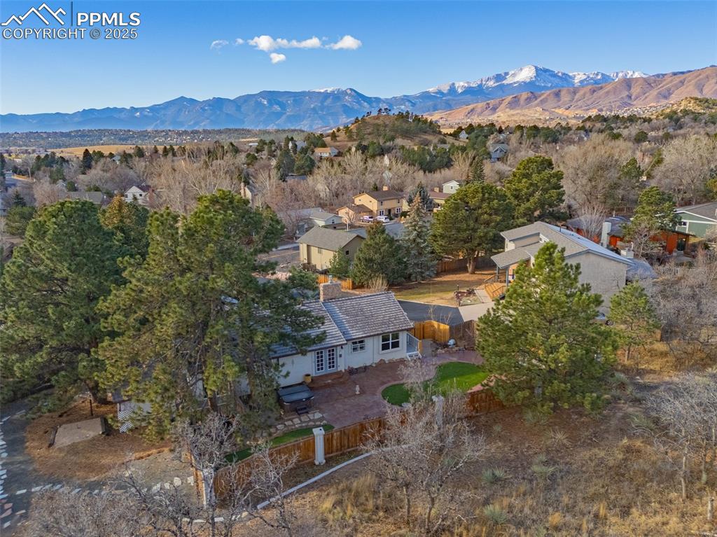 Image 45 of 50: Aerial view of residential area featuring a mountain backdrop