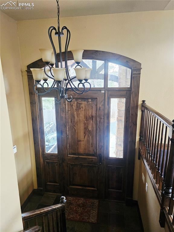 Image 7 of 50: Foyer with a chandelier
