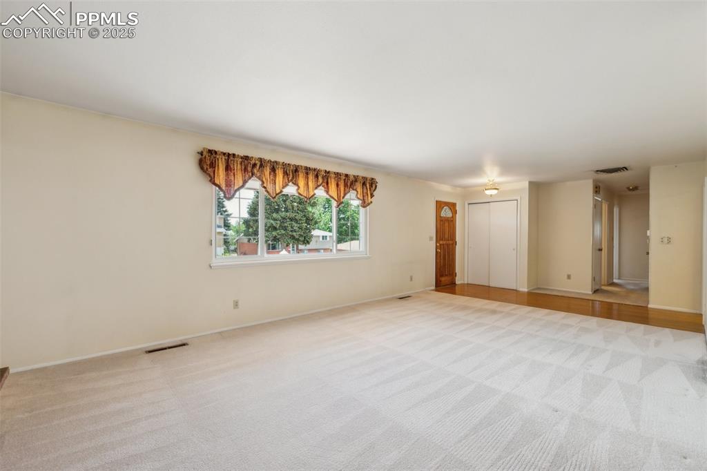 Image 10 of 30: Unfurnished room featuring light carpet