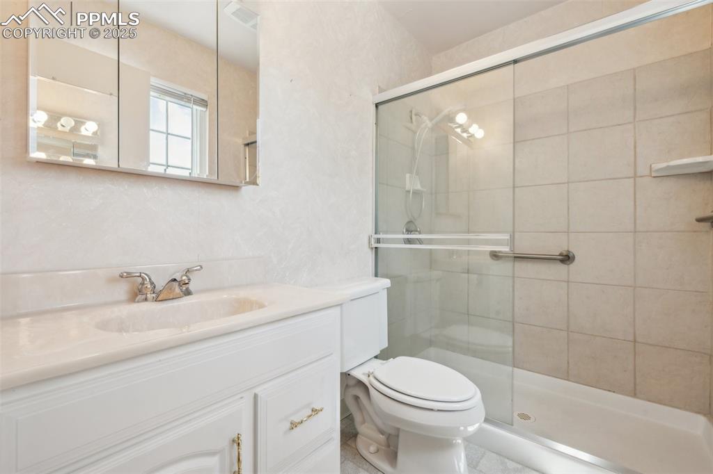 Image 19 of 30: Full bath with a stall shower and vanity