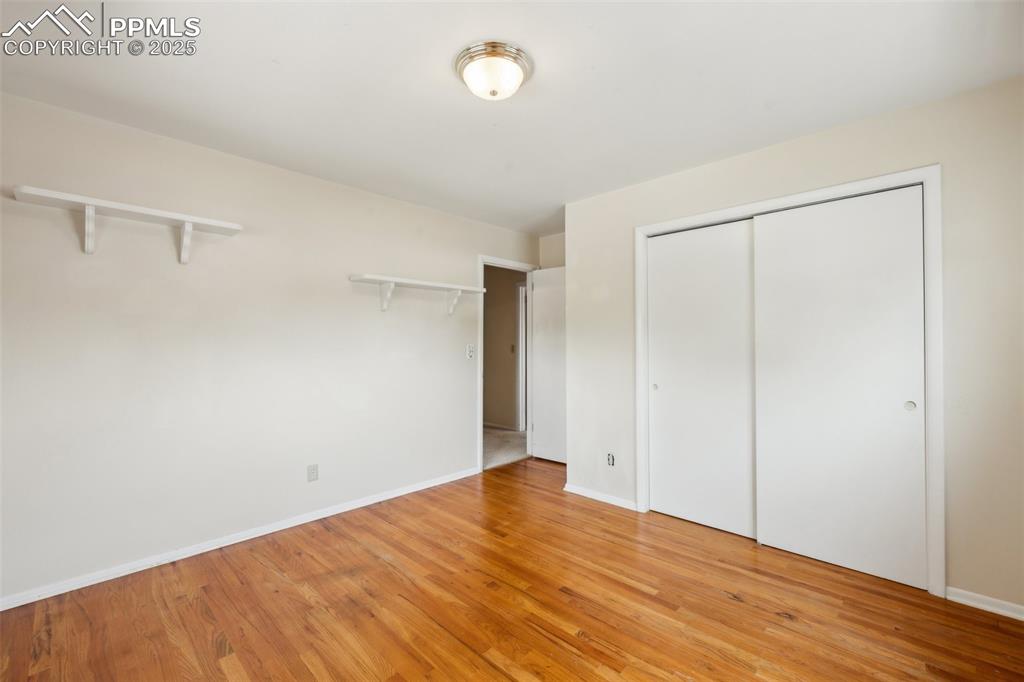 Image 21 of 30: Unfurnished bedroom with light wood-style flooring and a closet
