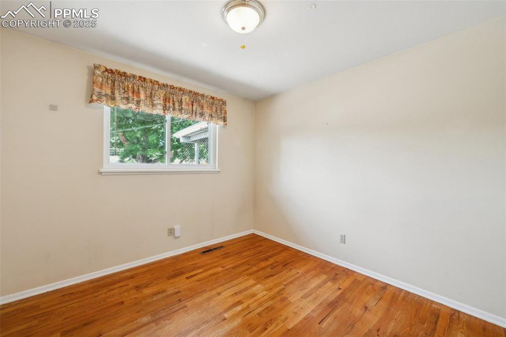 Image 22 of 30: Unfurnished room featuring light wood-style floors and baseboards
