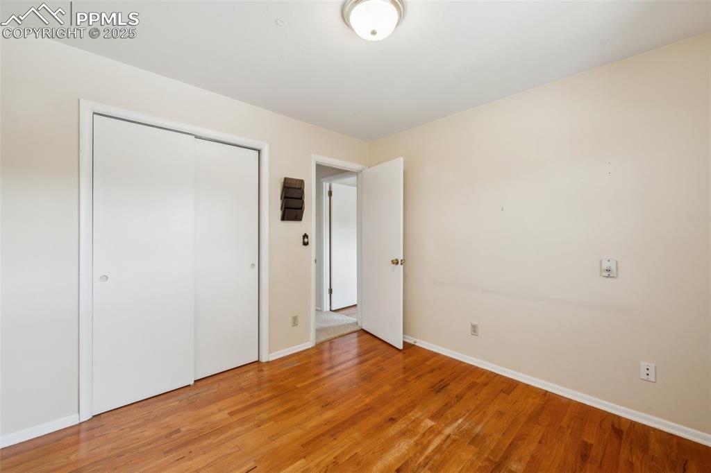 Image 23 of 30: Unfurnished bedroom with light wood-type flooring and a closet