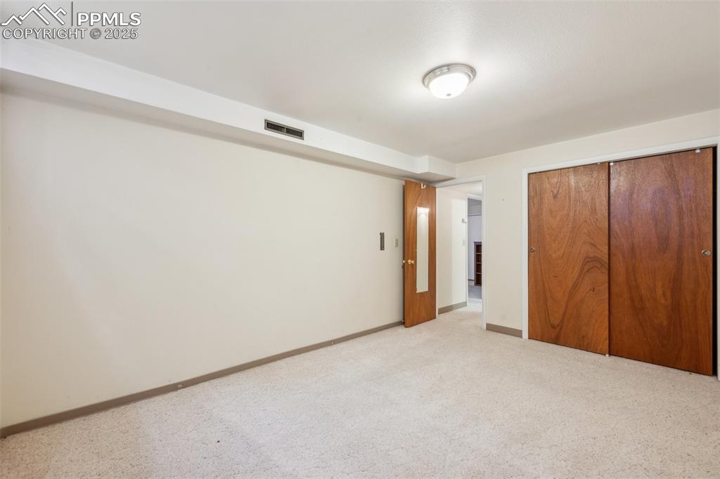 Image 28 of 30: Unfurnished bedroom featuring a closet and light carpet