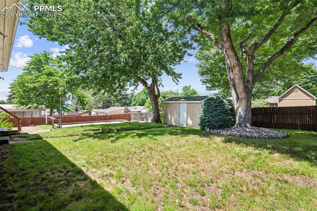 Image 4 of 30: Fenced backyard with a shed