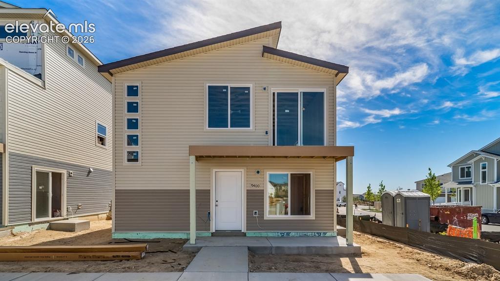 Image 1 of 18: Two-story residence featuring light-toned and dark-toned horizontal siding,