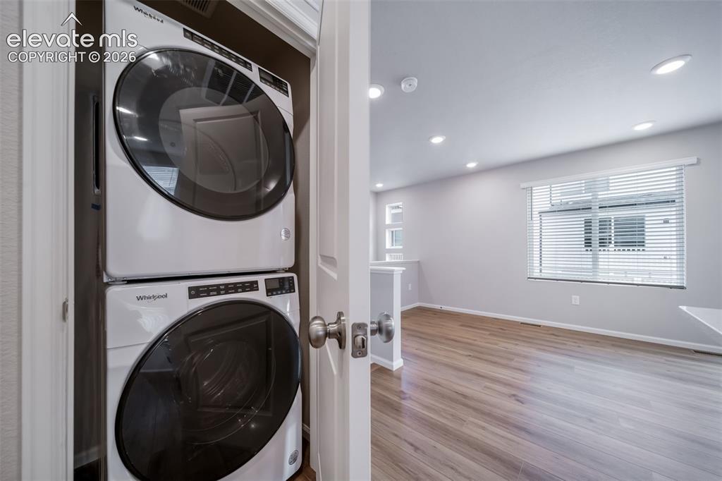 Image 18 of 18: Dedicated laundry closet featuring a white stacked washer and dryer unit
*