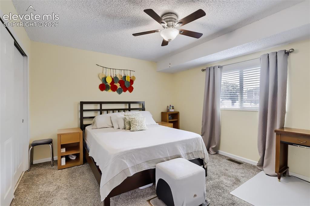 Image 10 of 19: Bedroom featuring carpet flooring, a ceiling fan with light fixture, and a