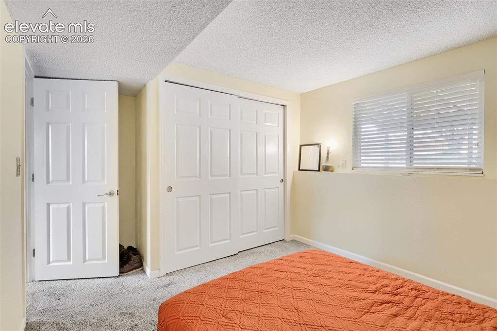 Image 14 of 19: Room featuring light-colored walls, textured ceiling, a window with horizon