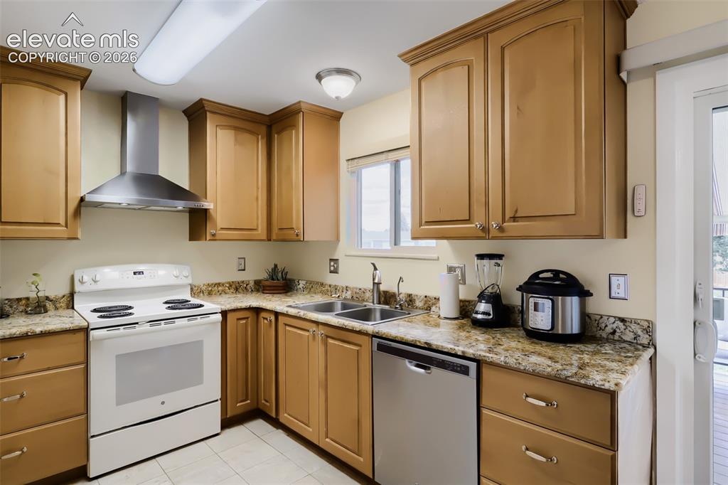 Image 4 of 19: Kitchen featuring light wood cabinetry, stone countertops, a stainless stee