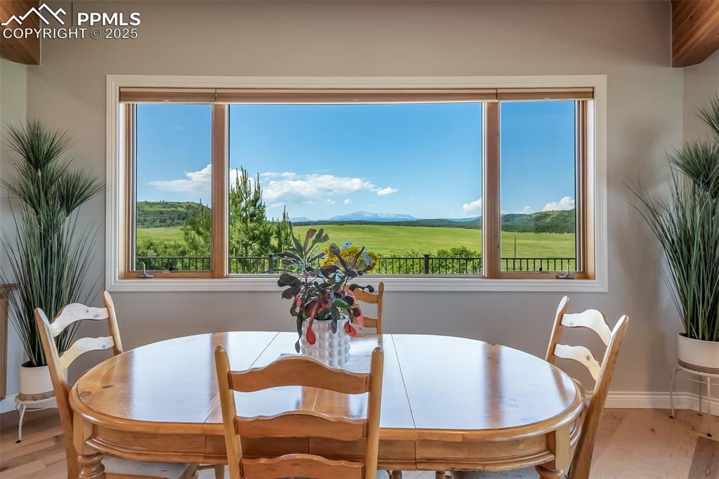 Image 12 of 50: Dining space with wood finished floors