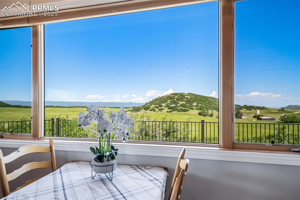 Image 14 of 50: Sunroom with a mountain view and plenty of natural light