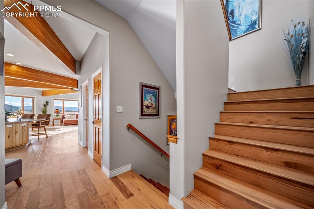 Image 19 of 50: Staircase featuring beam ceiling, wood-type flooring, and recessed lighting