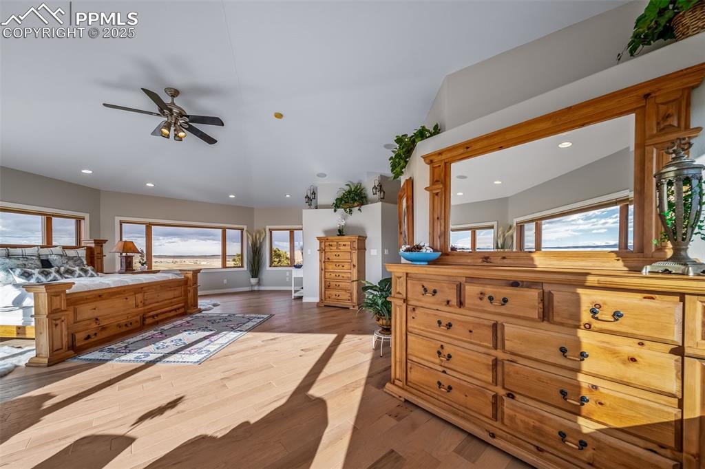 Image 24 of 50: Bedroom with multiple windows, wood finished floors, access to exterior, re