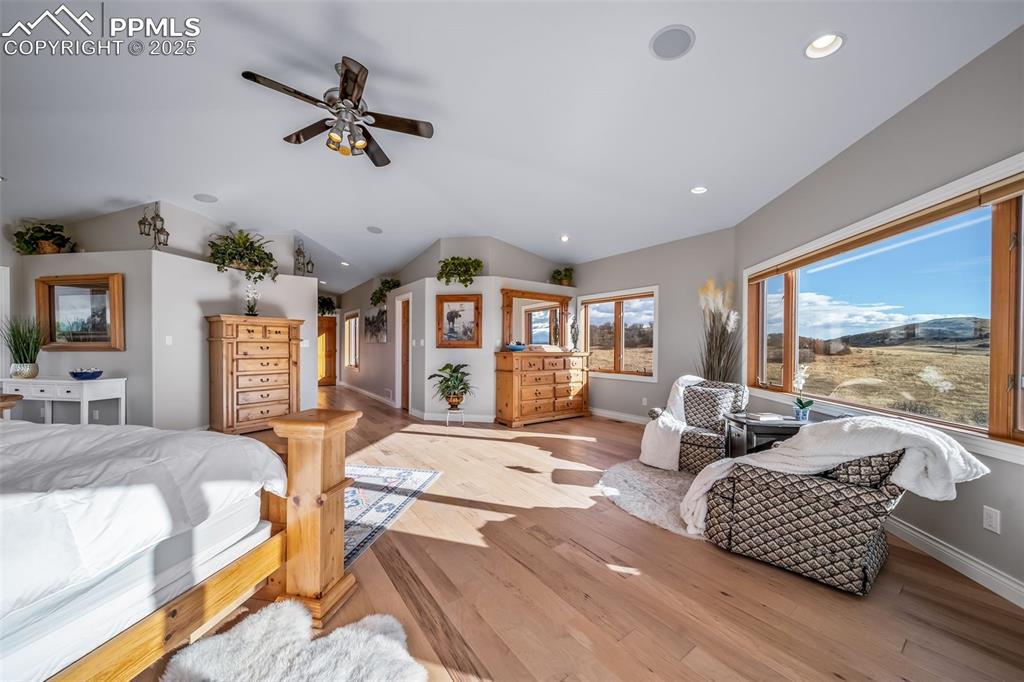 Image 25 of 50: Bedroom with lofted ceiling, wood finished floors, a ceiling fan, and reces