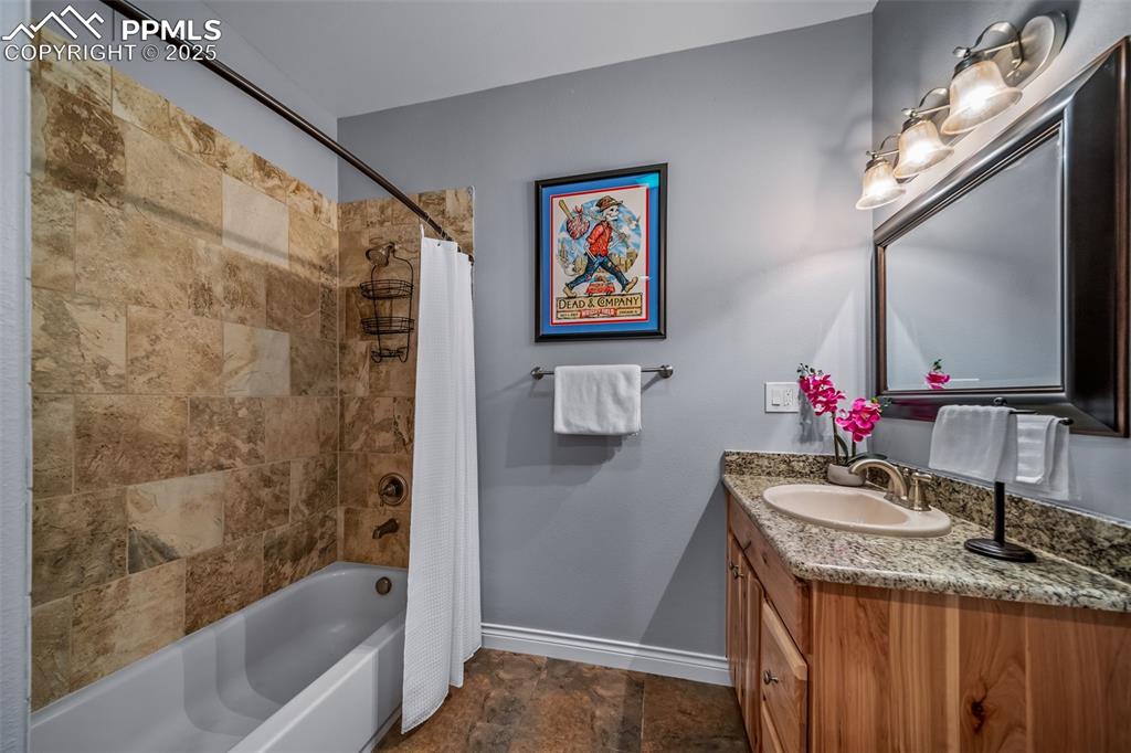 Image 36 of 50: Full bath featuring shower / bathtub combination with curtain, vanity, and 