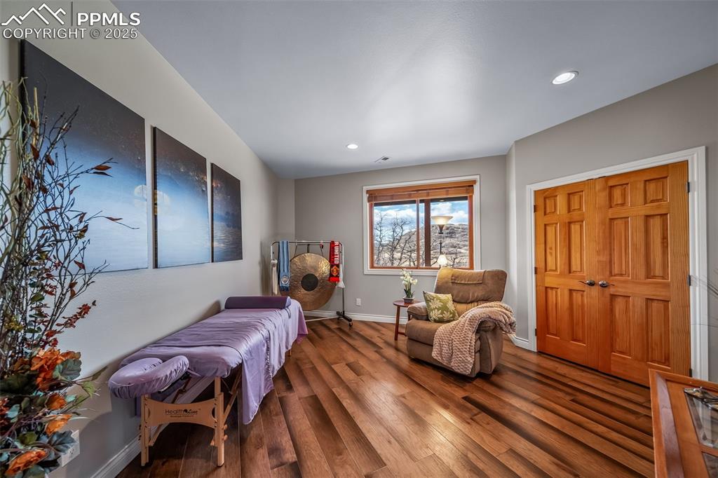 Image 37 of 50: Living area featuring wood finished floors and recessed lighting