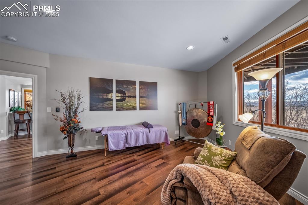 Image 38 of 50: Sitting room featuring plenty of natural light, recessed lighting, and wood