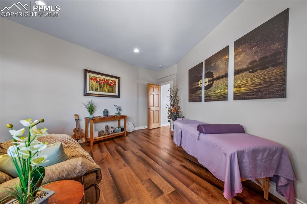 Image 39 of 50: Living area featuring wood finished floors and recessed lighting
