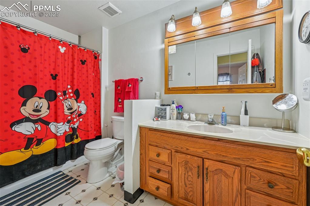 Image 21 of 21: Full bathroom featuring vanity and shower / tub combo with curtain