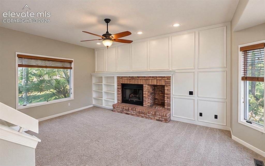 Image 4 of 8: Vaulted ceiling, ceiling fan, recessed lighting, brick gas fireplace, and b