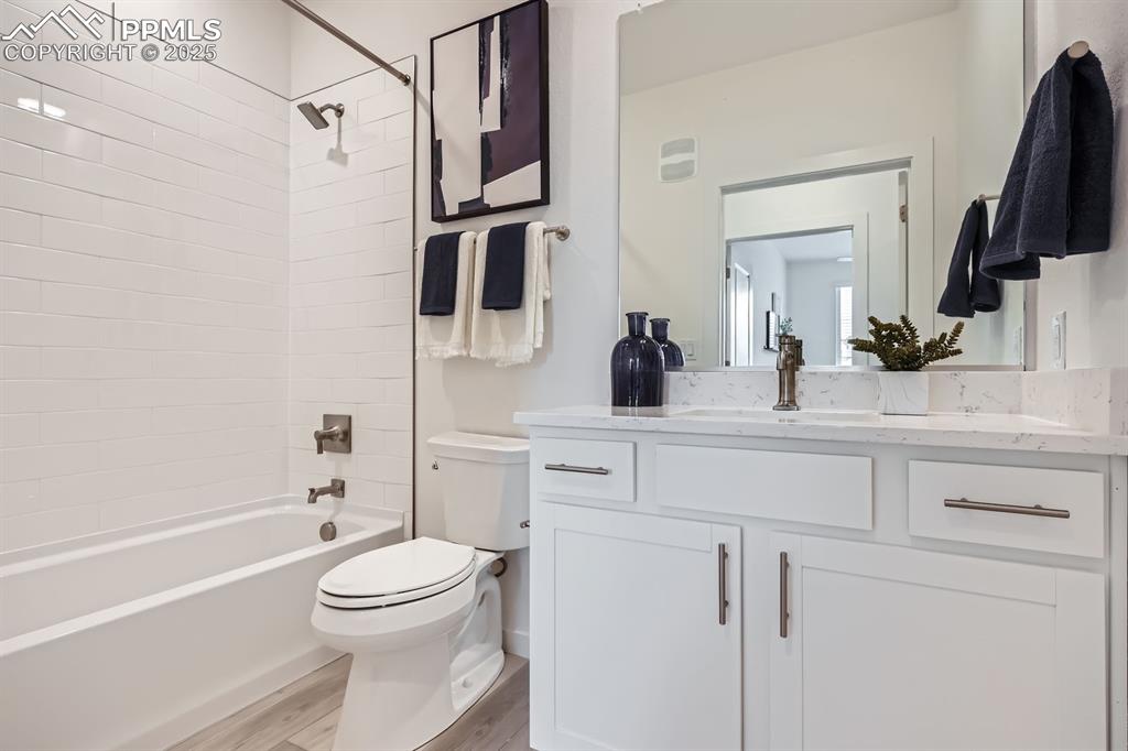 Image 8 of 9: Full bathroom with shower / bathtub combination, light wood-style floors, a