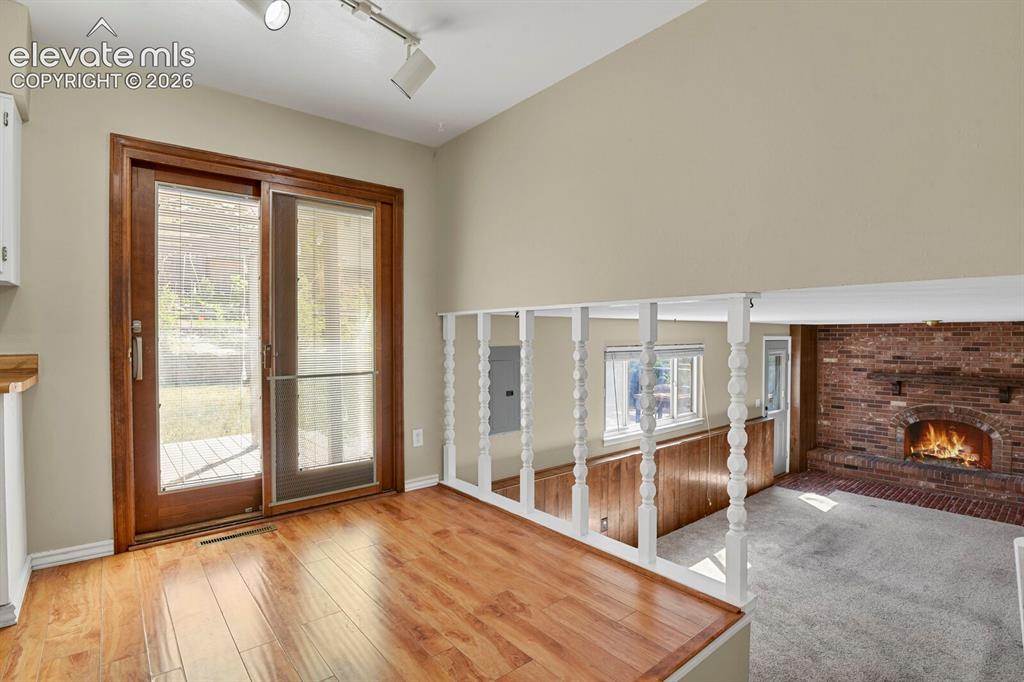 Image 13 of 34: Bright interior space featuring wood-finish flooring and a white architectu