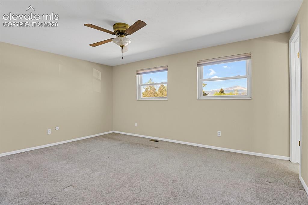 Image 14 of 34: Spacious room featuring neutral carpet flooring and light-toned wall paint