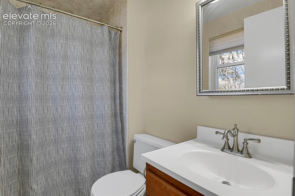 Image 16 of 34: Bathroom featuring a vanity with a white countertop and undermount sink, br