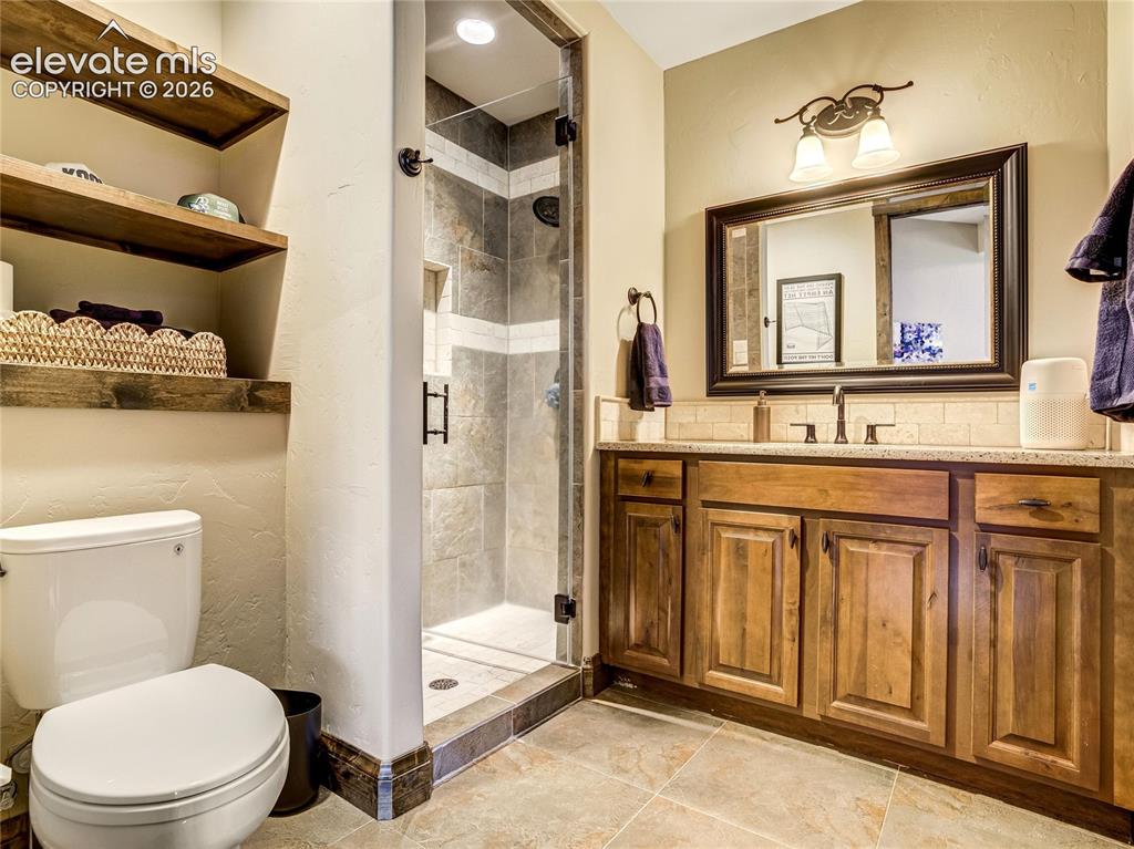 Image 26 of 50: A richly detailed walk-in shower elevates the primary bath experience with 
