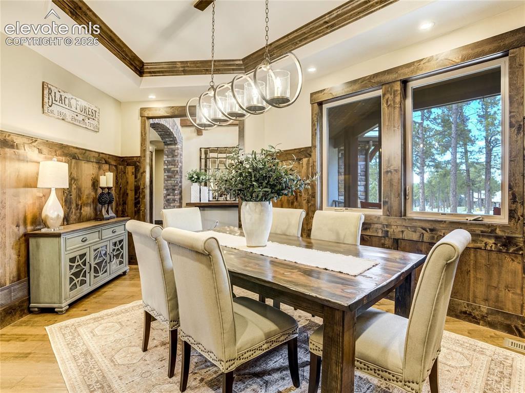 Image 9 of 50: Rustic wood details create an inviting gathering space within the eat-in no