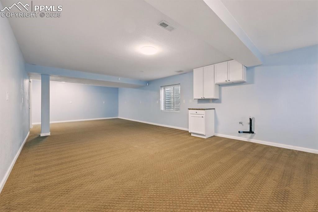 Image 31 of 42: Basement with wet bar rough in