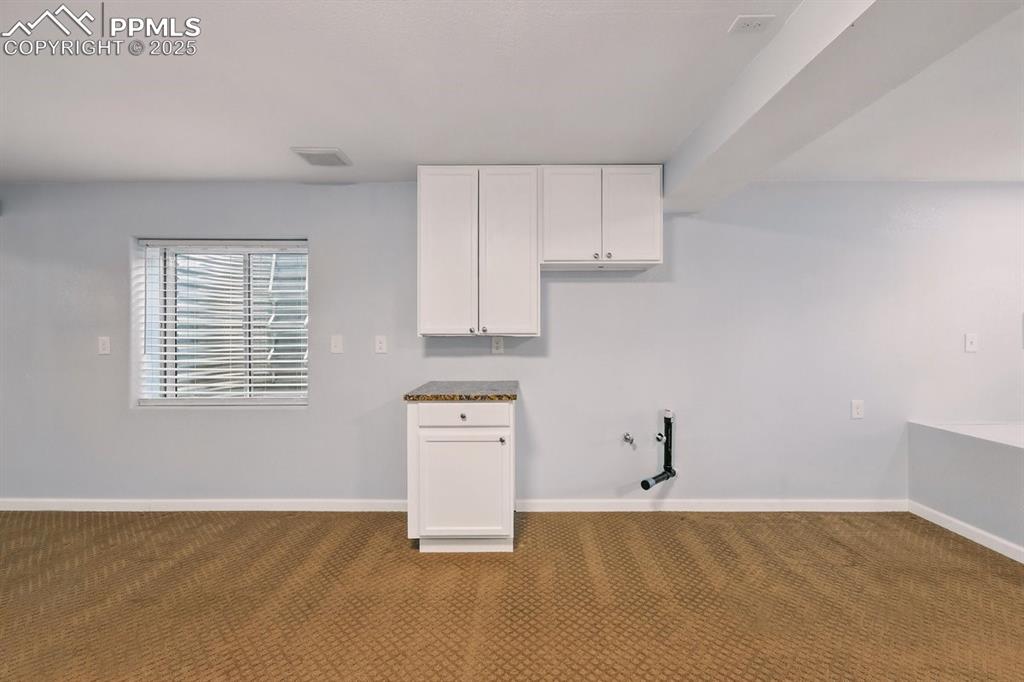 Image 32 of 42: Basement with wet bar rough in