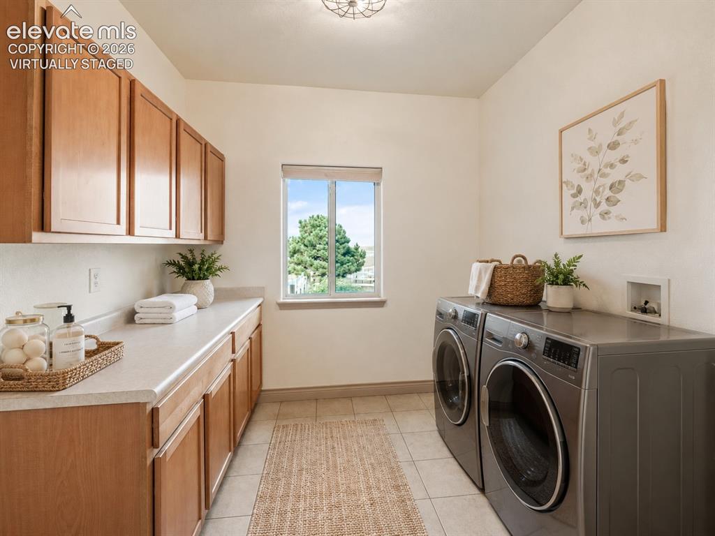 Image 18 of 49: Virtually Staged: Laundry room with wood-finish cabinetry, light-toned coun