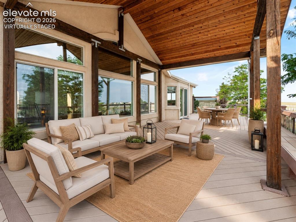 Image 39 of 49: Virtually Staged: Expansive outdoor deck featuring a vaulted wood-paneled c
