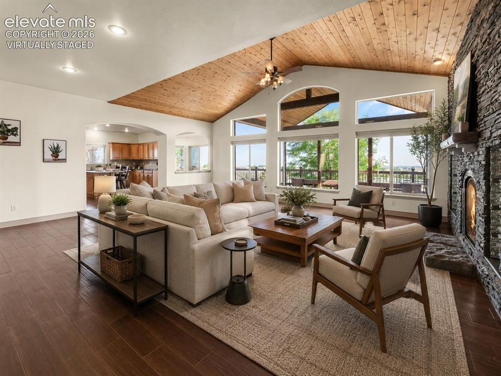 Image 8 of 49: Virtually Staged: Vaulted wood-paneled ceiling, expansive windows, stacked
