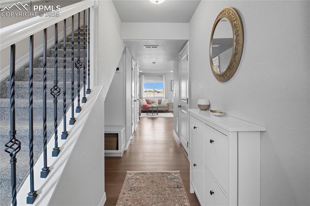Image 4 of 31: THOUGHTFULLY DESIGNED ENTRYWAY WITH A BUILT-IN CABINET