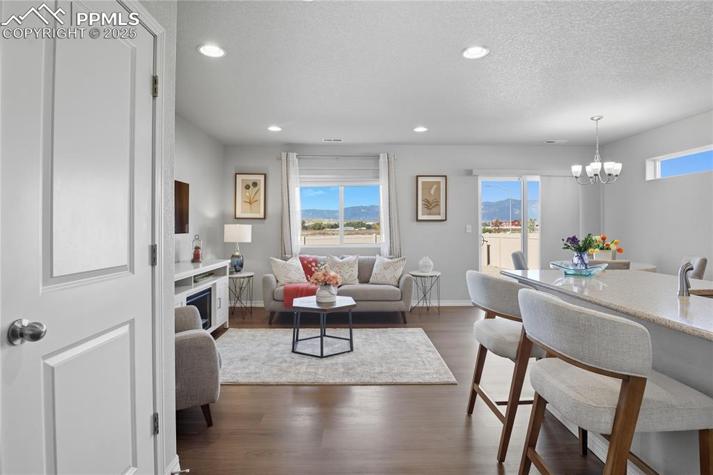 Image 6 of 31: MAIN LEVEL OPENS INTO A BRIGHT AND AIRY LIVING ROOM