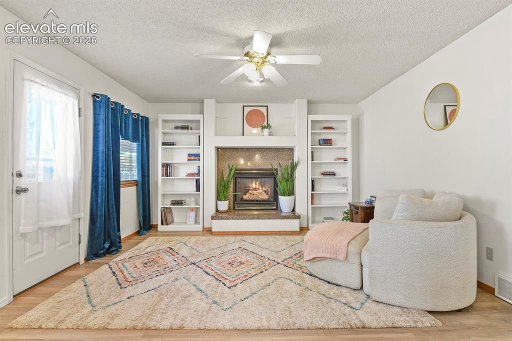 Image 10 of 44: Family Room off kitchen with gas fireplace.