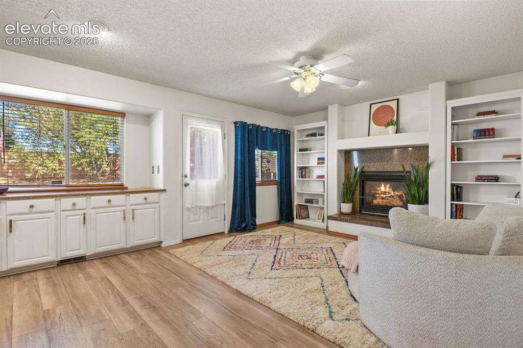 Image 12 of 44: Family Room looking towards door to the backyard and coffee bar area.
